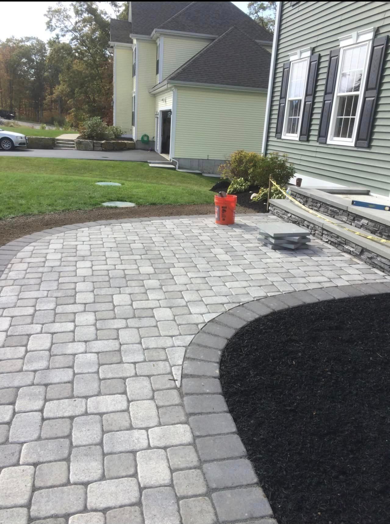 a brick walkway is being built in front of a house