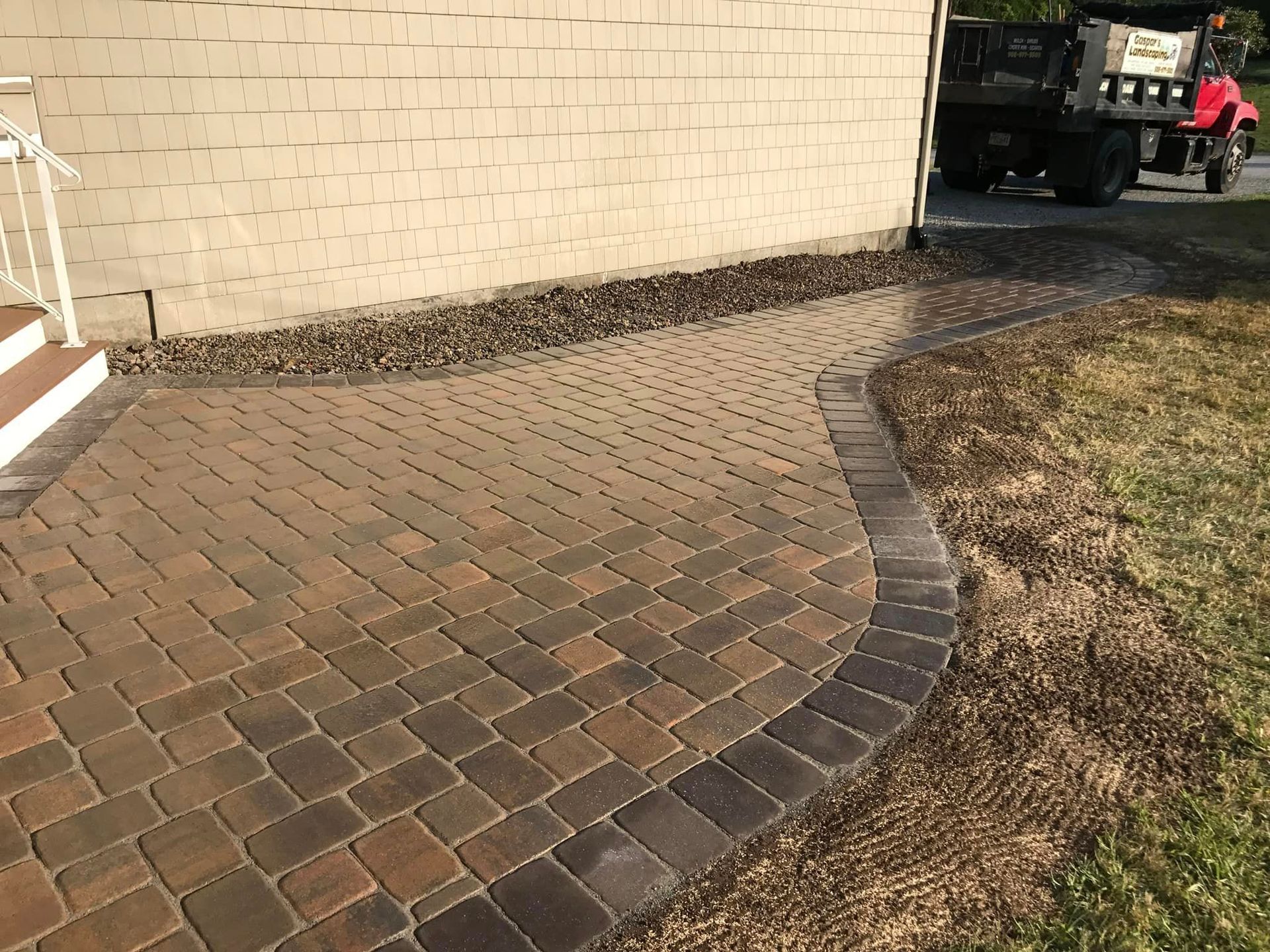 a brick walkway is being built in front of a brick building