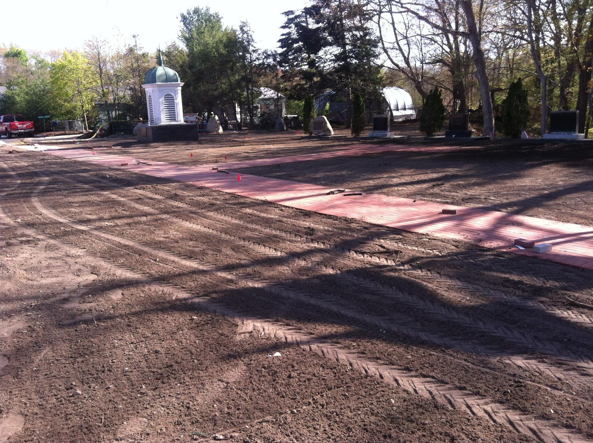 a large dirt field with a few trees in the background