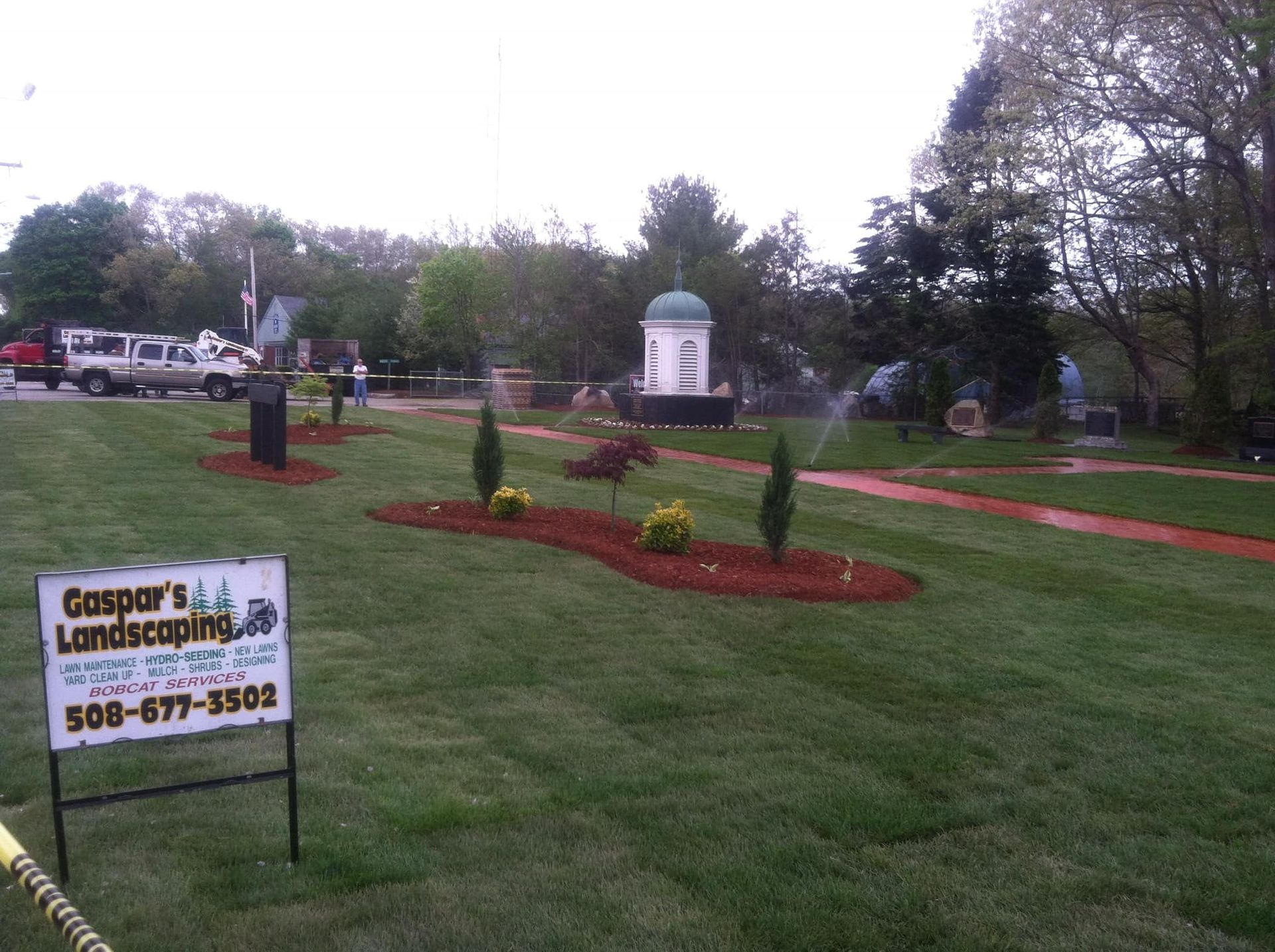 a sign for Gaspar's landscaping is in front of a lush green lawn
