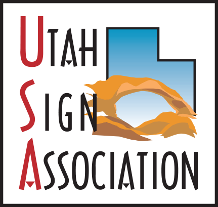 A logo for the utah sign association with a desert scene