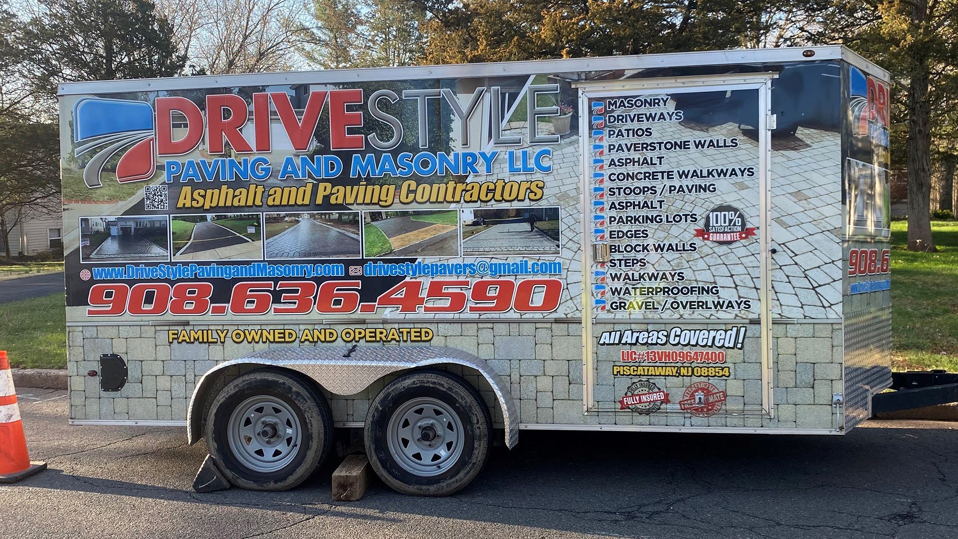 Trailer with “DRIVESTRUCT” advertising graphics parked outdoors on pavement