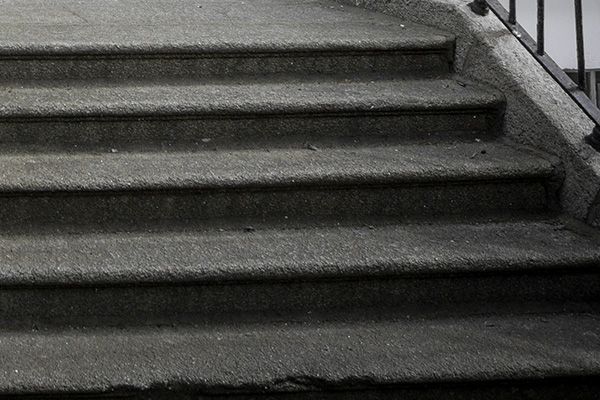 Concrete stairs with a metal handrail on the right side