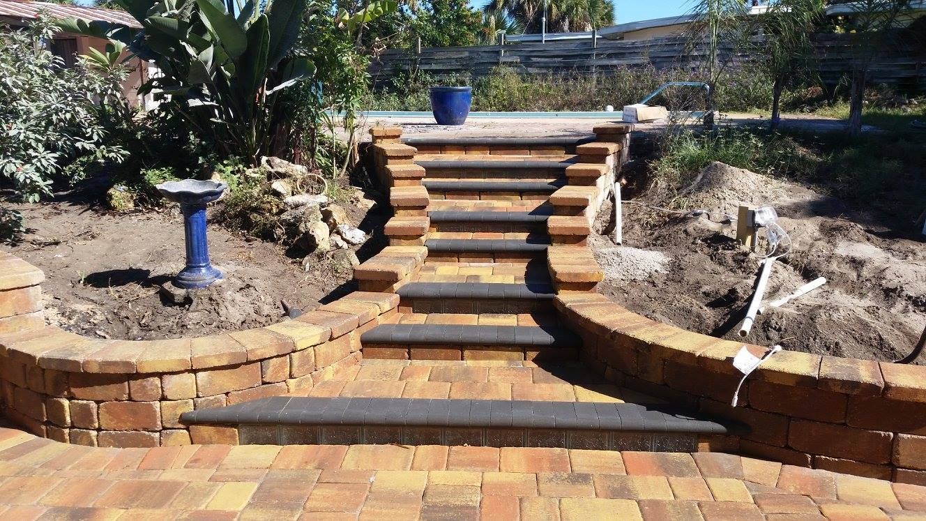 Brick staircase with retaining walls leading to a garden area.