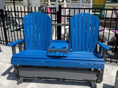 Blue two-seat bench with cup holders on a black metal frame outdoors