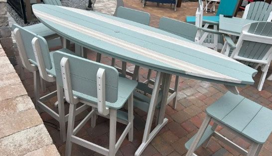 Light blue striped outdoor table with matching chairs on a patio.