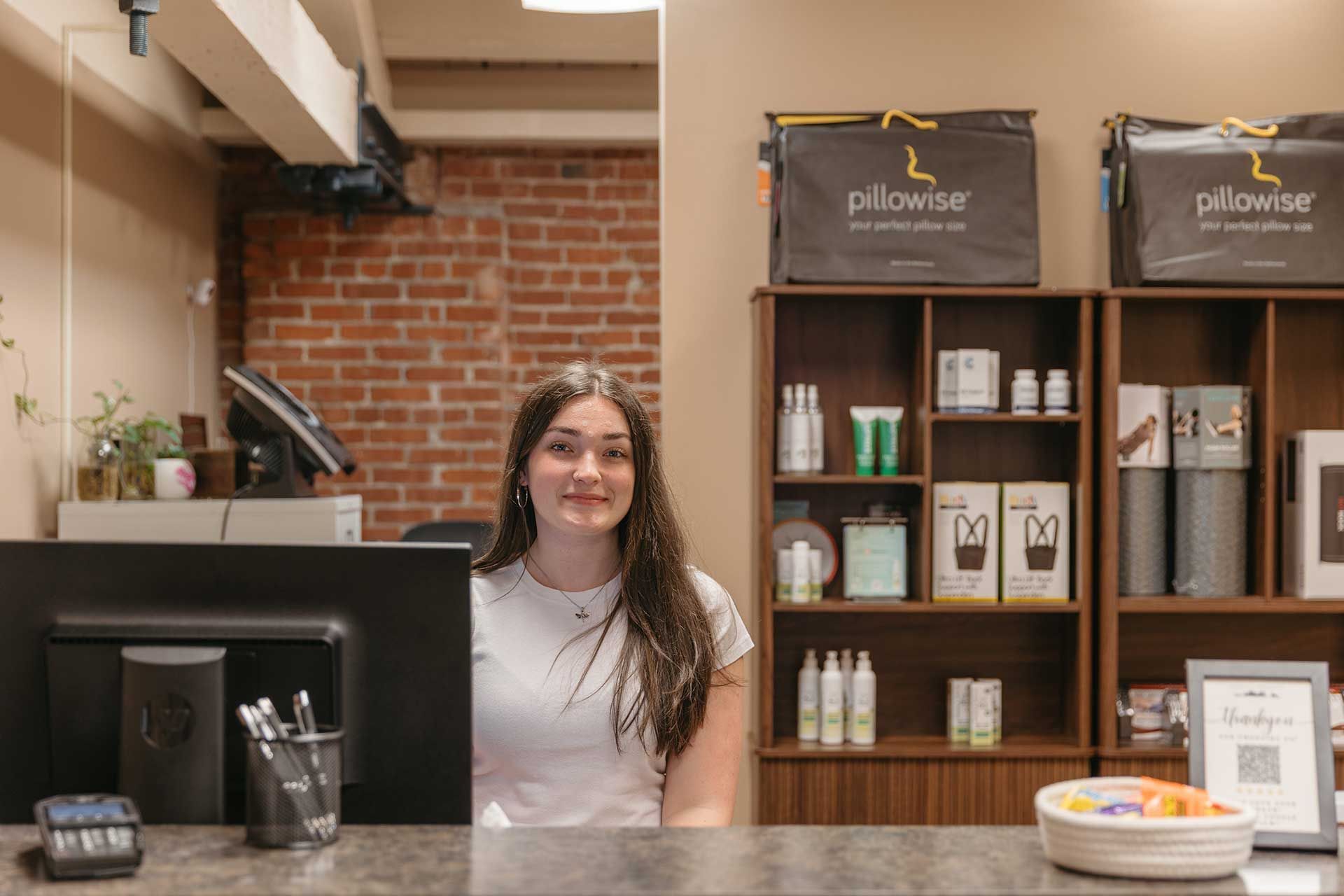 a receptionist behind a counter in a clinic