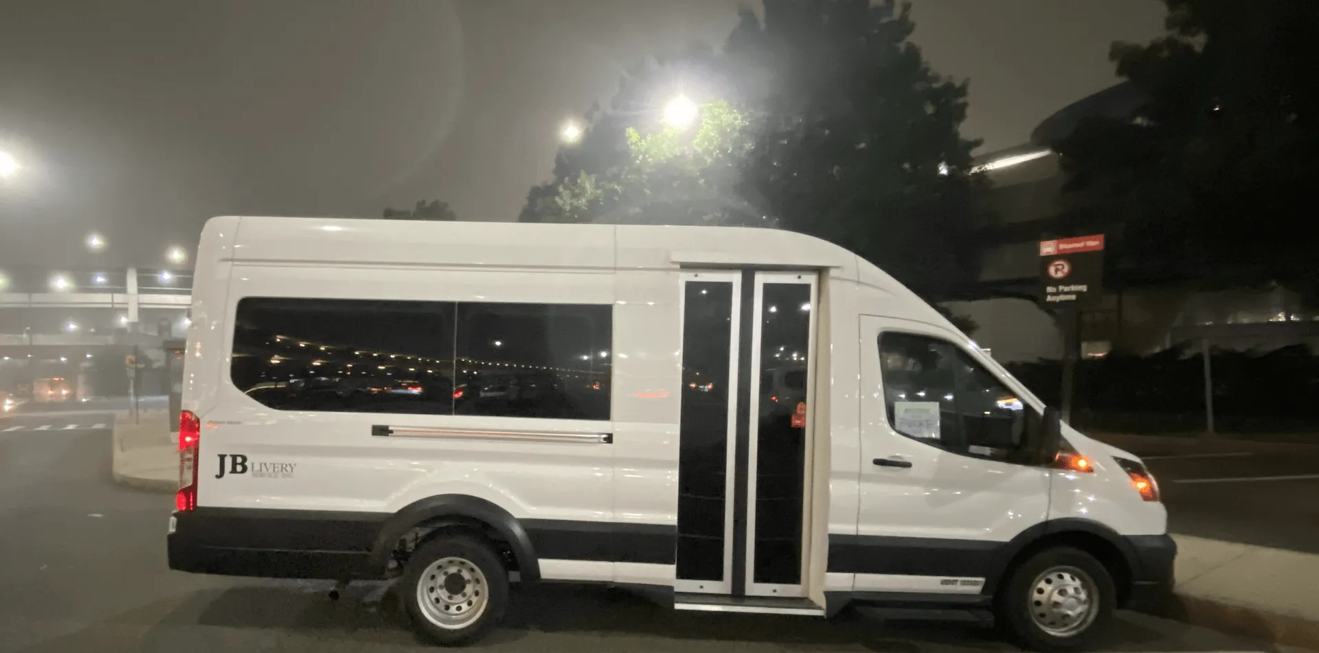 White van with open door at night.