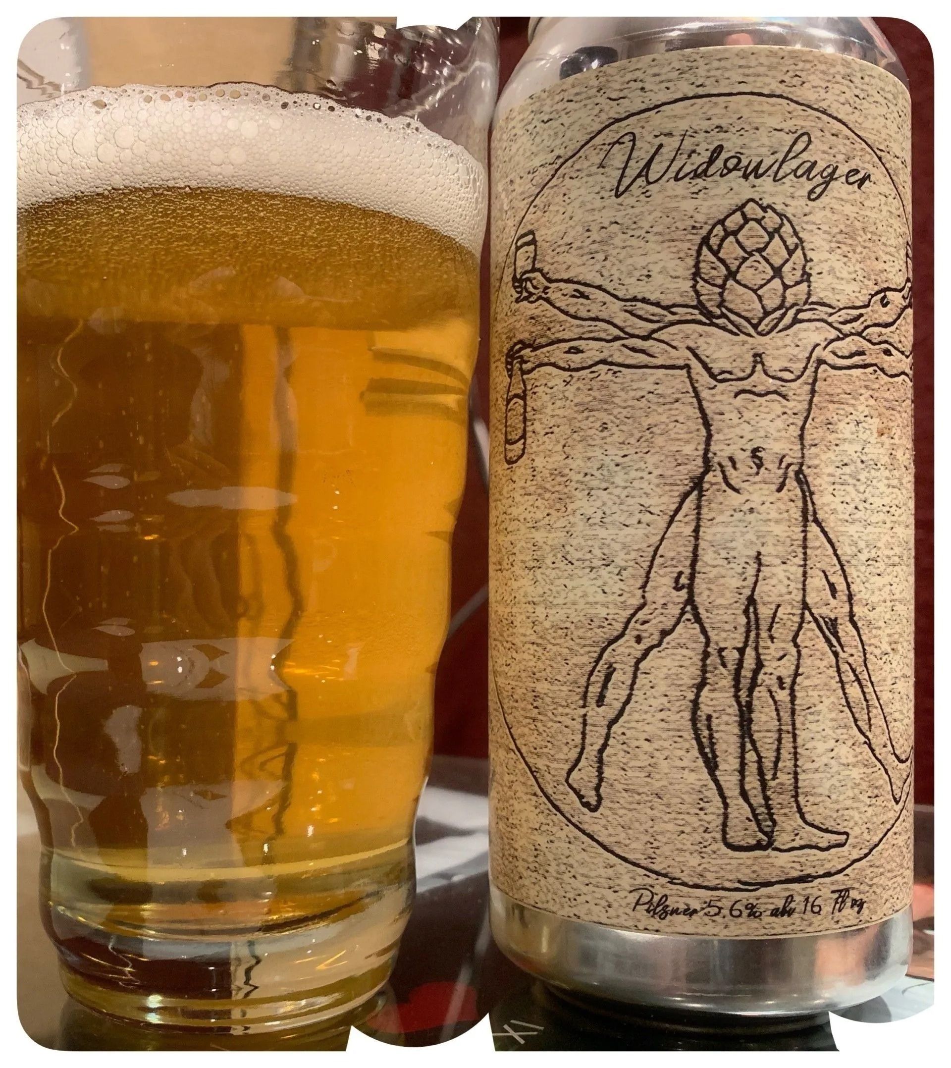 Glass of beer next to a can of