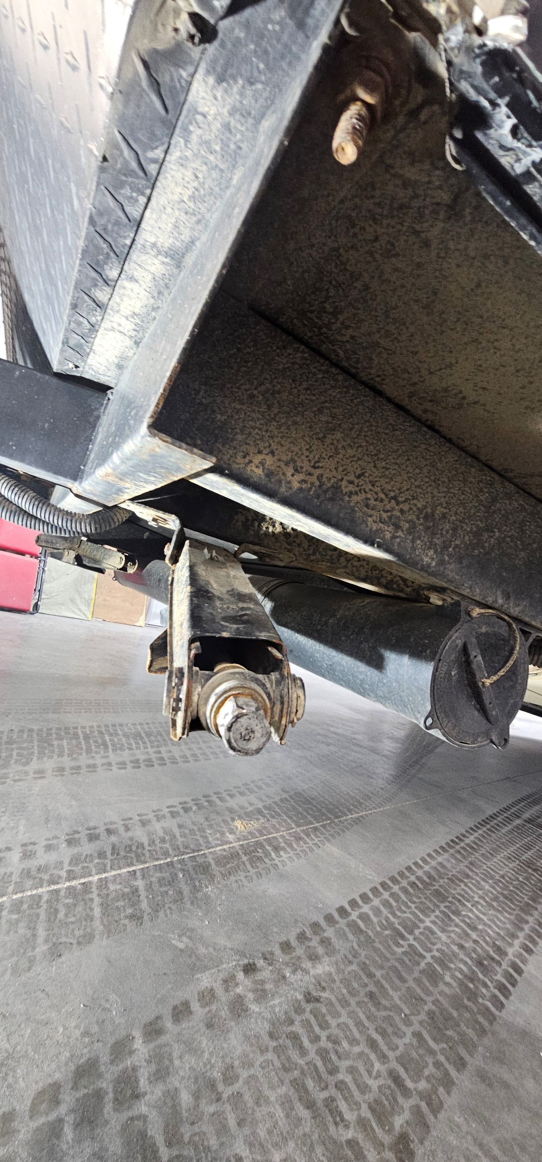 A close-up of the underside of an RV in a garage.