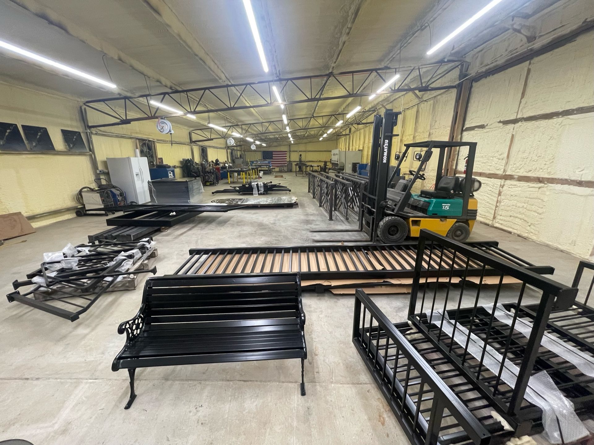 a large warehouse filled with furniture and a forklift