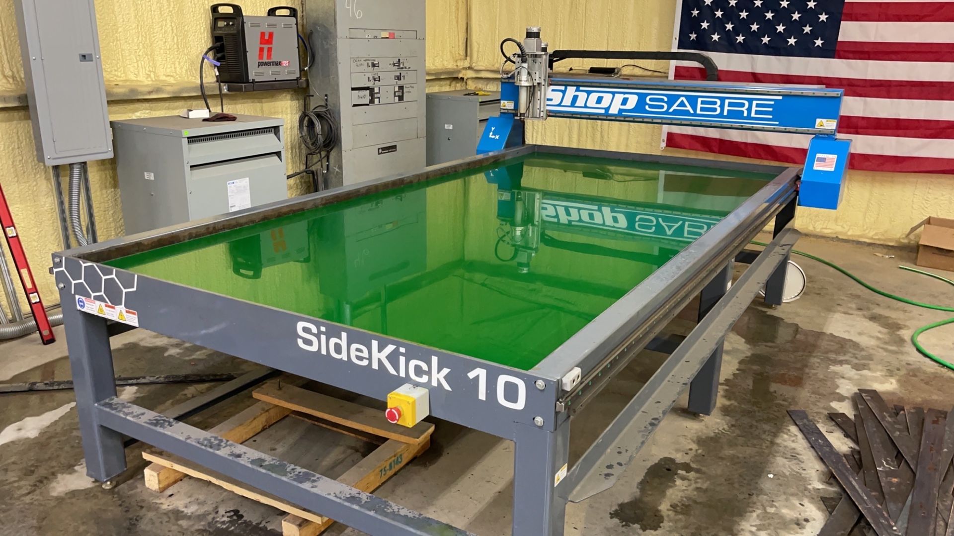 a table with a green top is sitting in front of an American flag