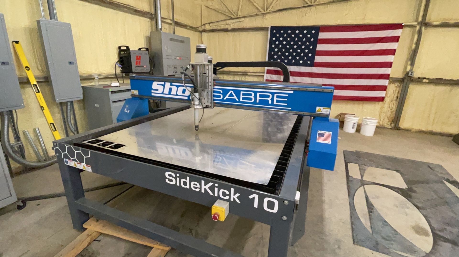 a machine is sitting in a room with an American flag in the background