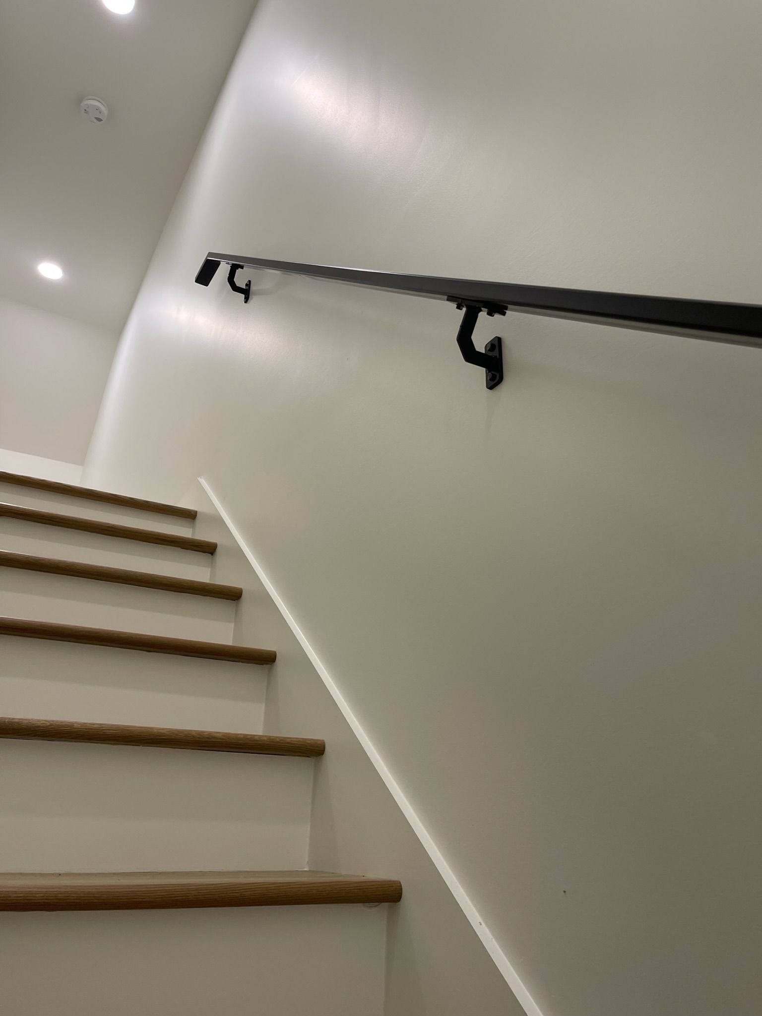 a staircase with a hand rail on the wall