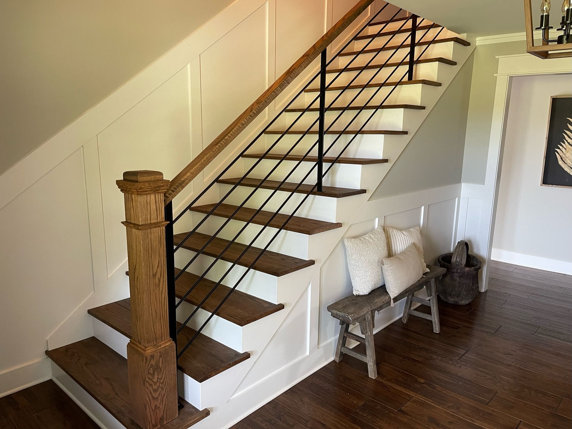 a staircase with wooden steps and a metal railing in a hallway