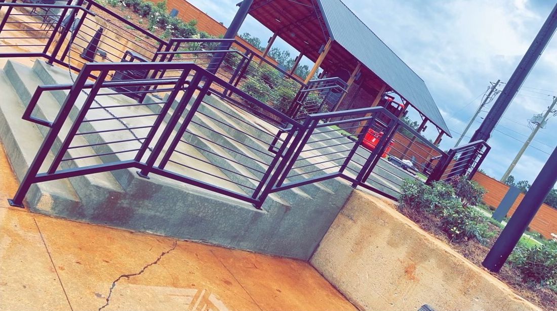 a staircase with a metal railing leading up to a building