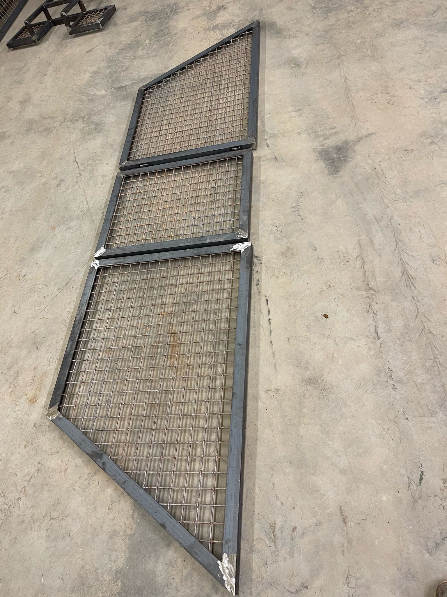 a metal fence is sitting on top of a concrete floor