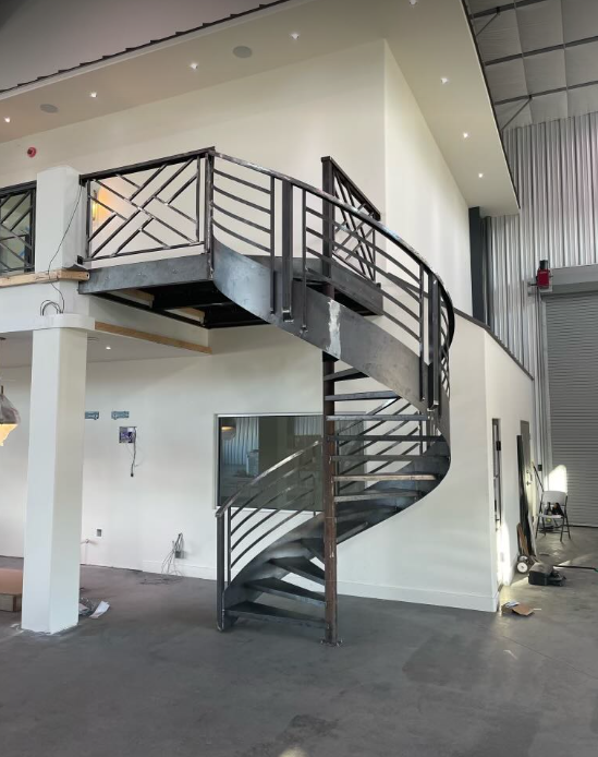 a spiral staircase in a building with a balcony