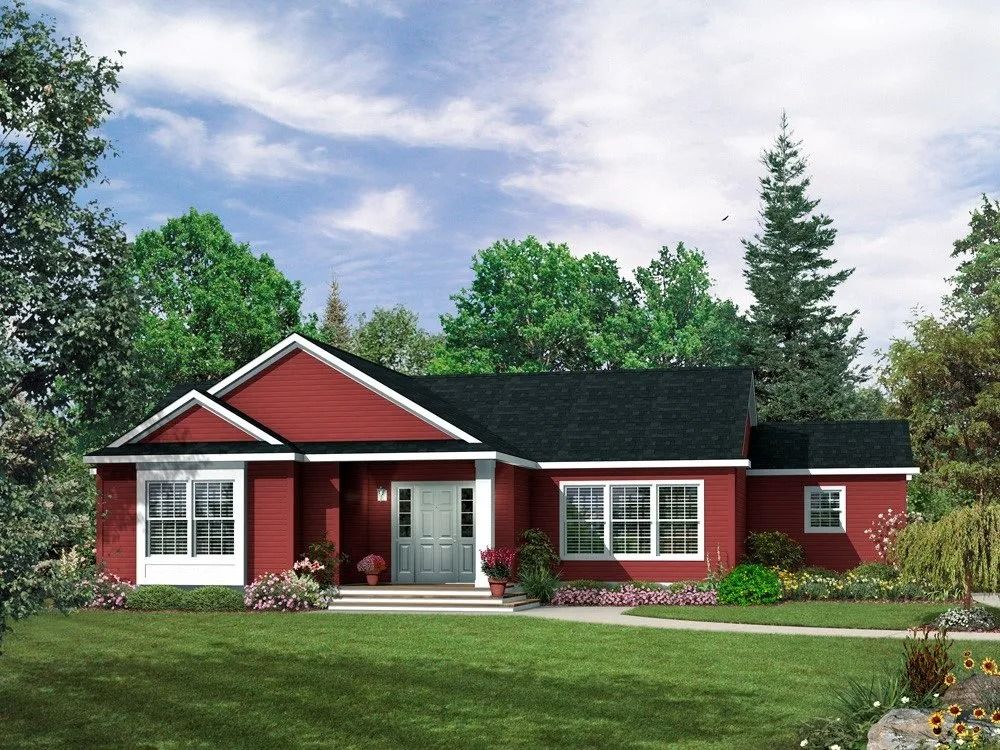 Red, one-story house with white trim, black roof, and front lawn under a blue sky.
