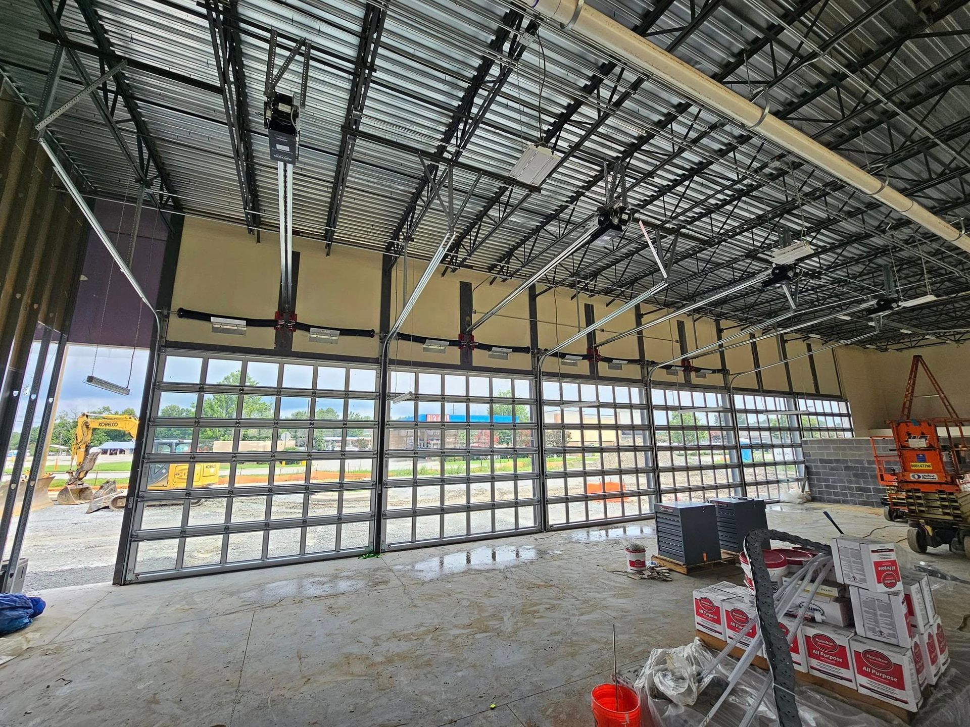 A large garage door is being built in a building under construction.