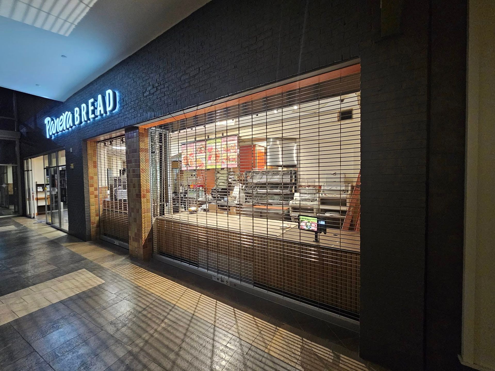 A store front of a bakery in a mall.