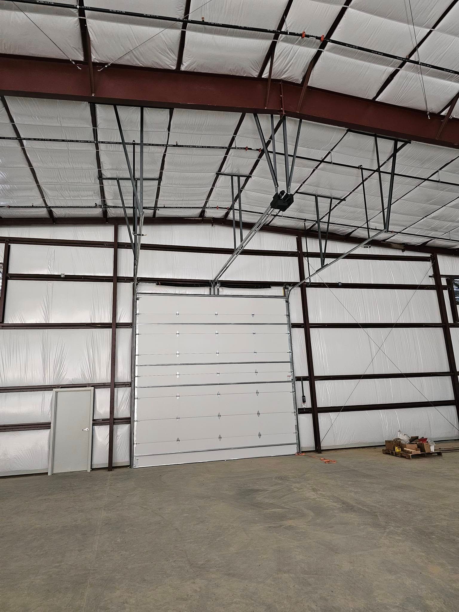 A large empty warehouse with a large garage door.