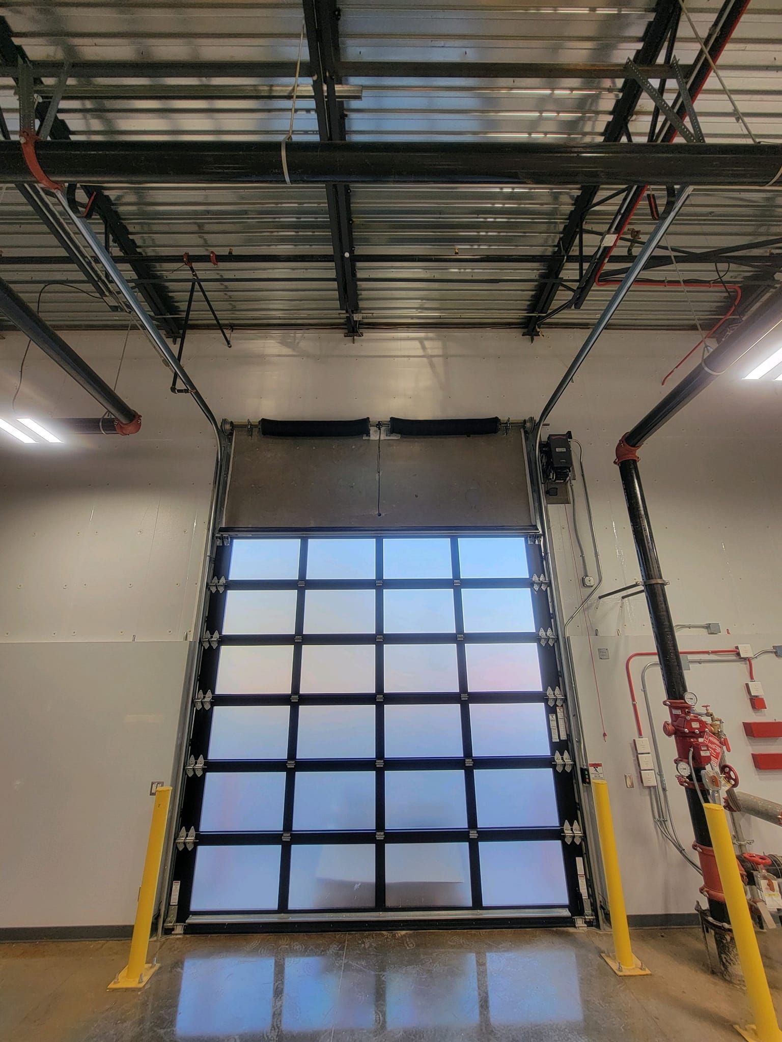 A large garage door is open in a building.
