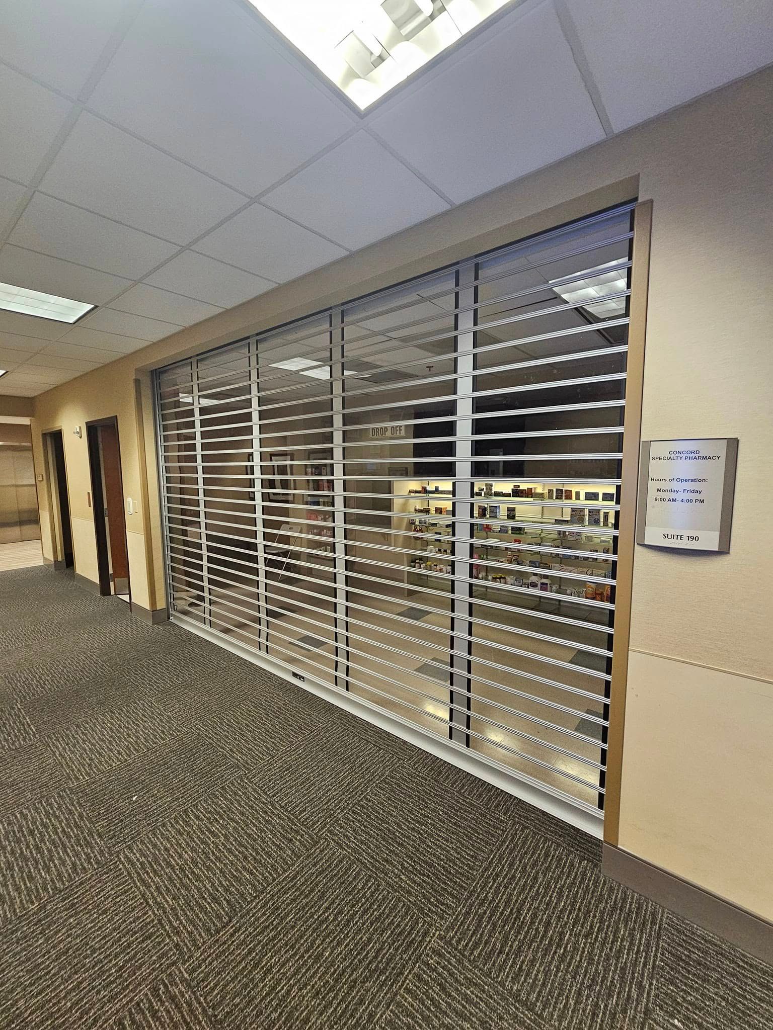 A hallway with a staircase and a sliding glass door.