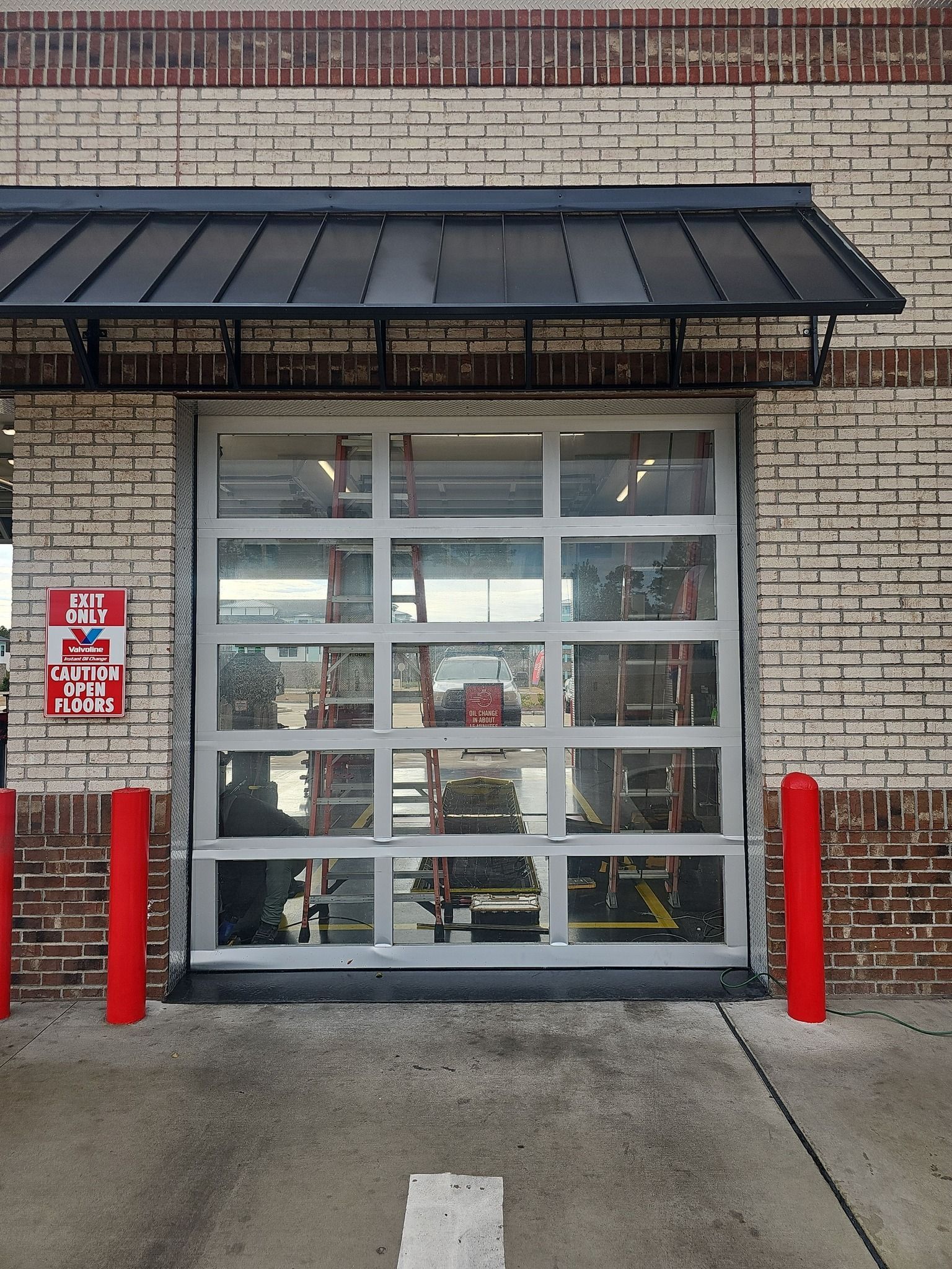A garage door with a sign that says 24 hours