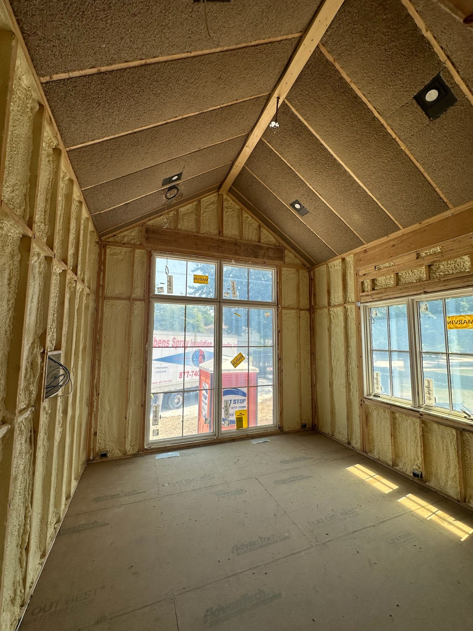 A room with a lot of windows and foam on the walls.