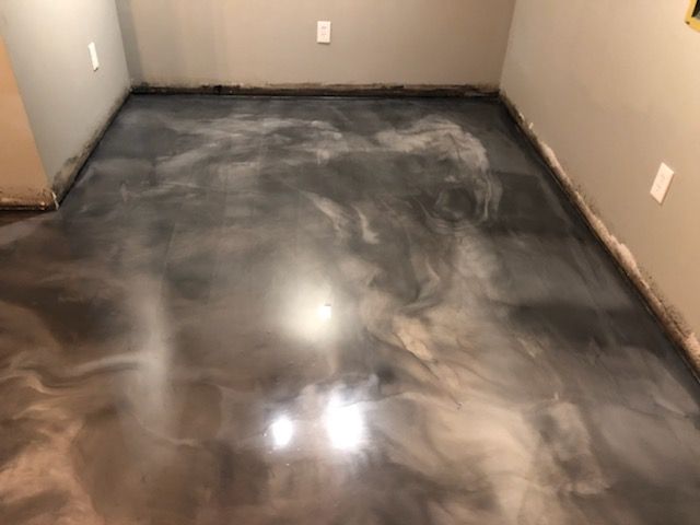 Metallic gray epoxy floor in a room with light gray walls.