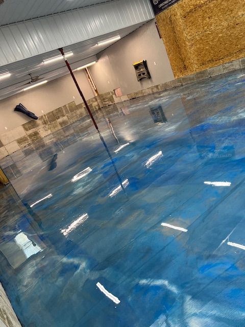 Blue and silver metallic epoxy floor in a large, bright room.