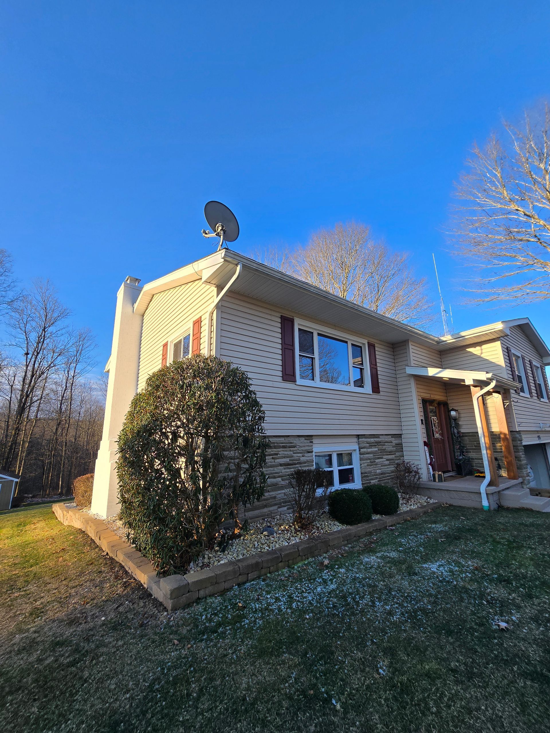 A house with a satellite dish on top of it.