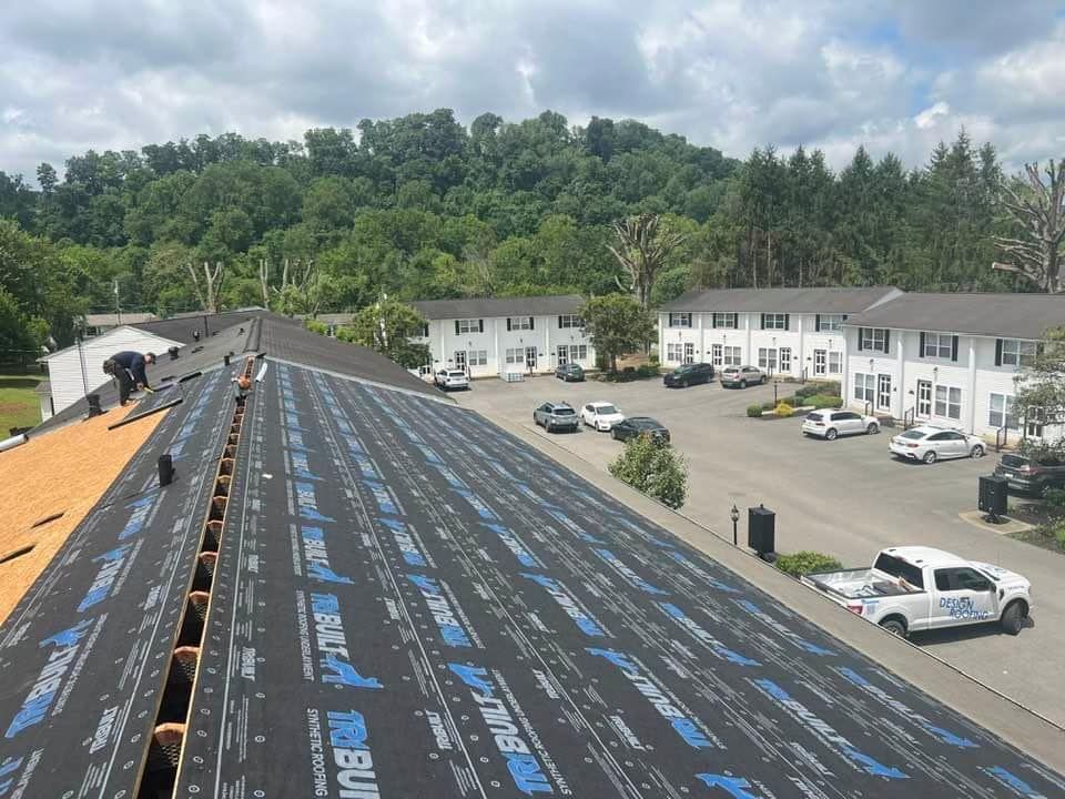 Damaged asphalt shingle roof with missing and torn shingles. A logo for