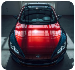 Red sports car, top view, parked inside a brightly lit building. Reflective surface.