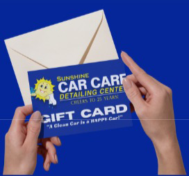 Hands holding a gift card and an envelope.