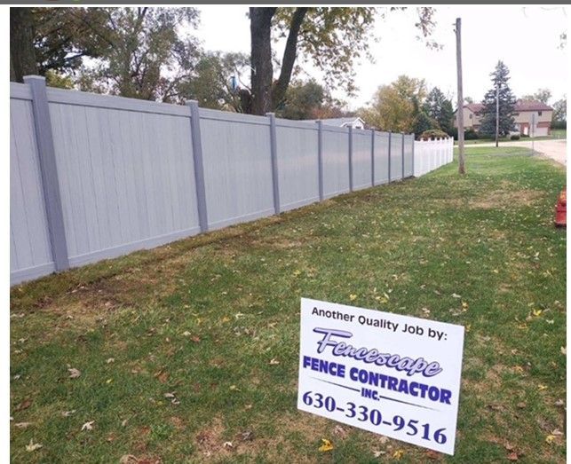 A fence with a sign that says fence contractor on it