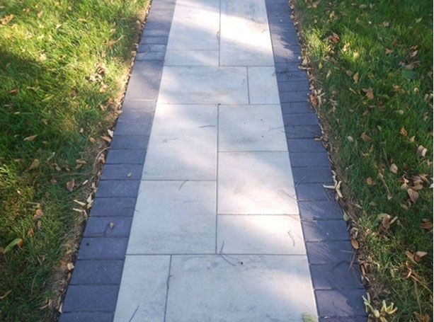 A walkway with a black and white stripe on the side