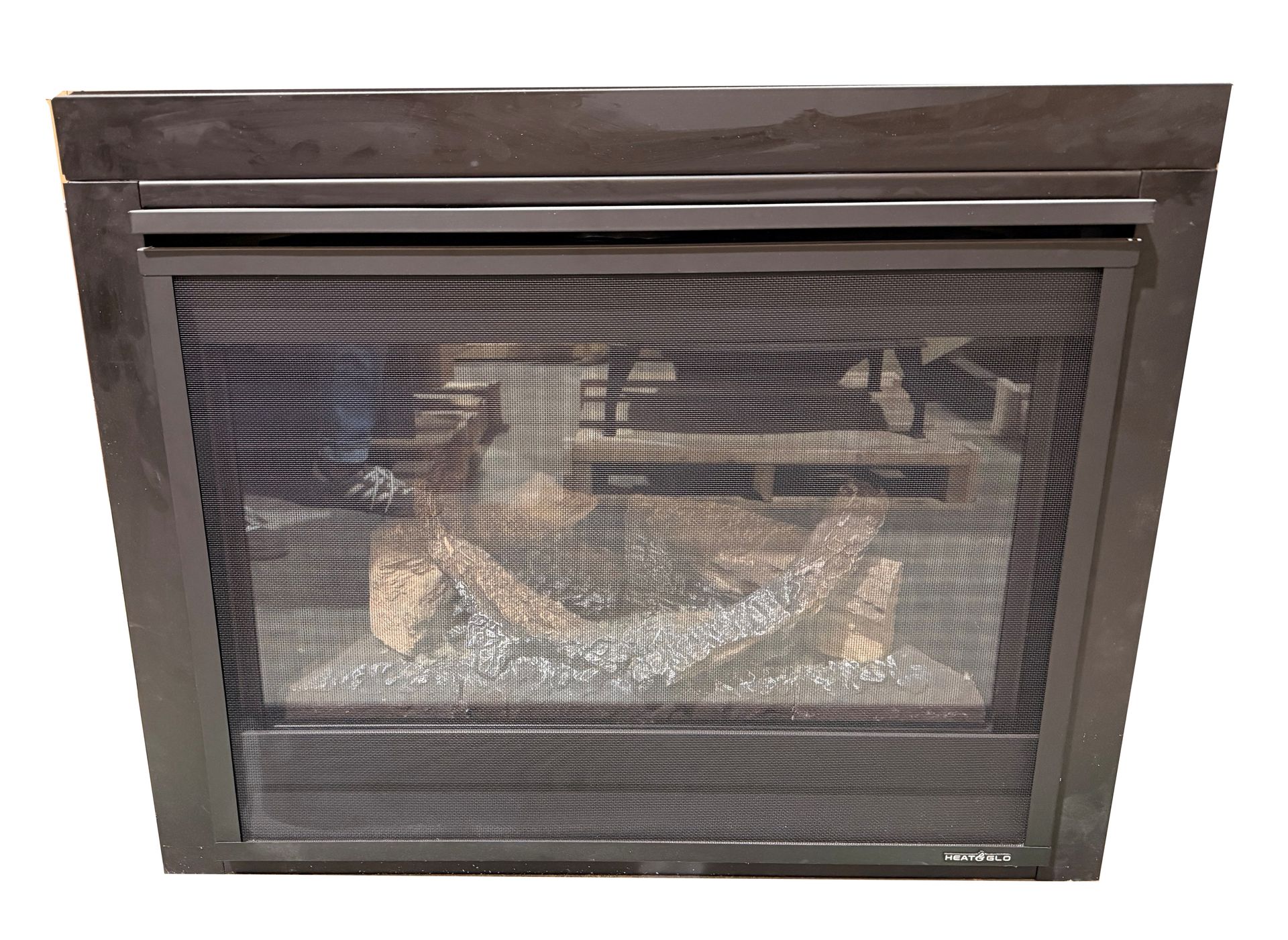 Dark fireplace insert with glass door and visible logs inside