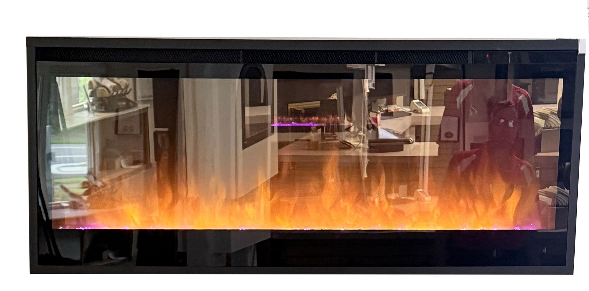 Modern black fireplace with orange flames and glass front in a living room