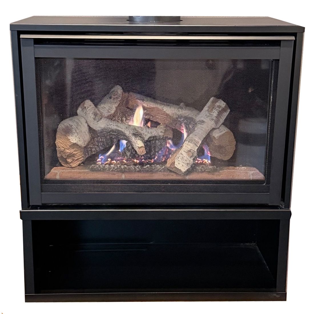 Black gas fireplace insert with flames behind a screen and a storage shelf below.