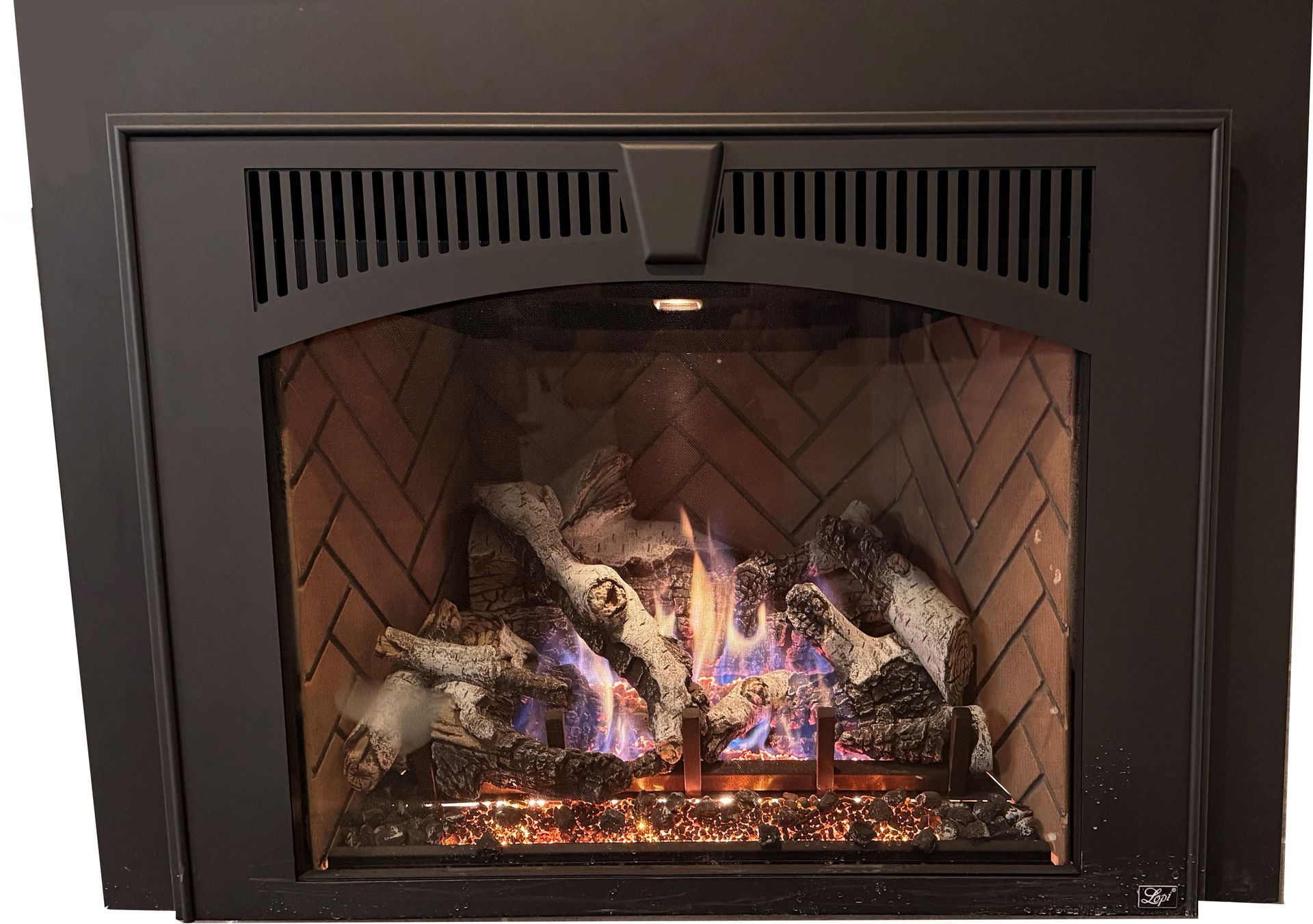 Fireplace with flames burning behind a black metal frame and brick-lined interior