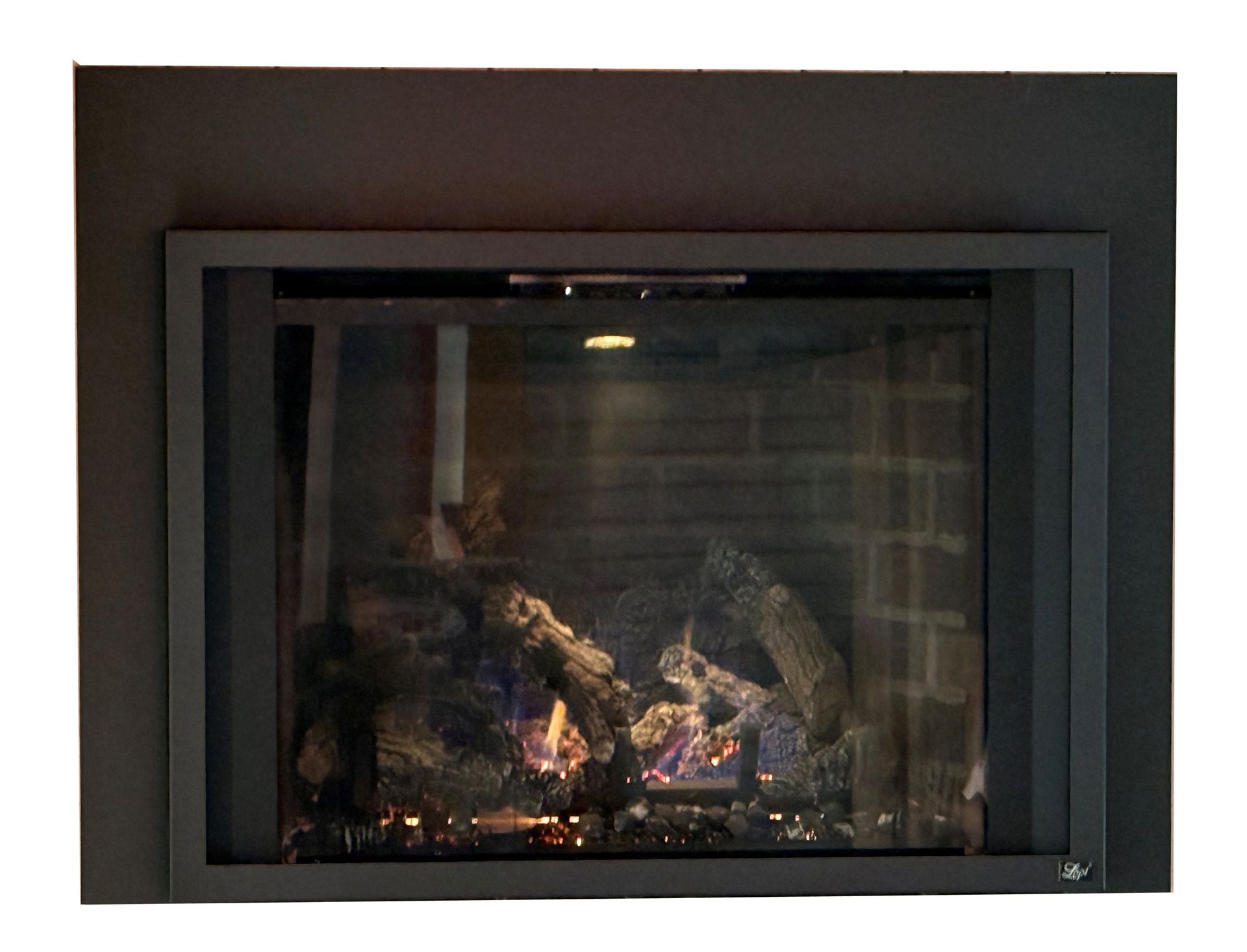 Modern black fireplace with glass front and glowing flames inside