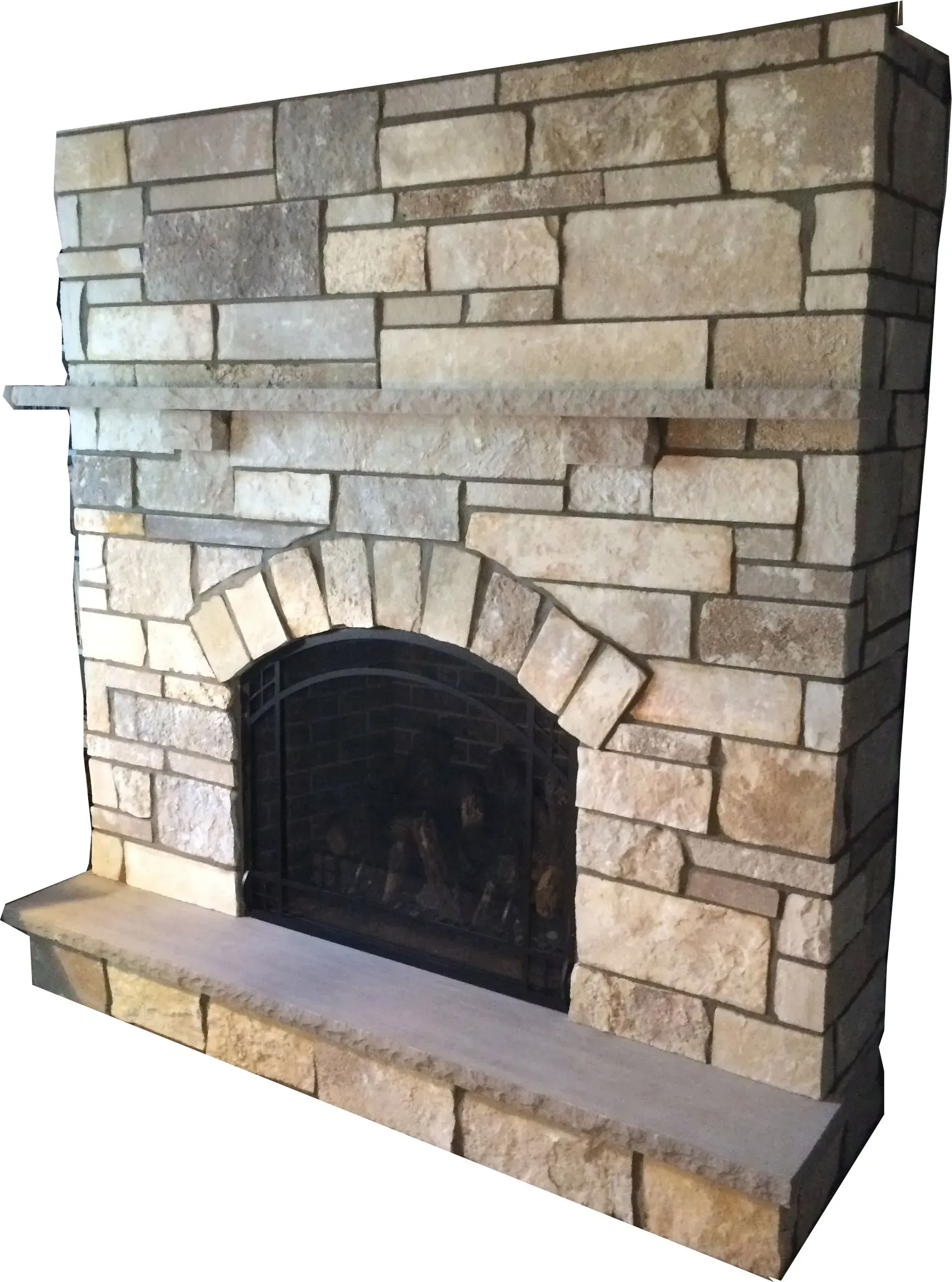 Stone fireplace with a dark arched opening, topped with a stone mantle and shelf.