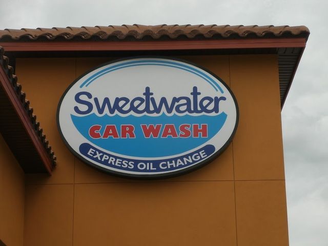 A sign for sweetwater car wash express oil change