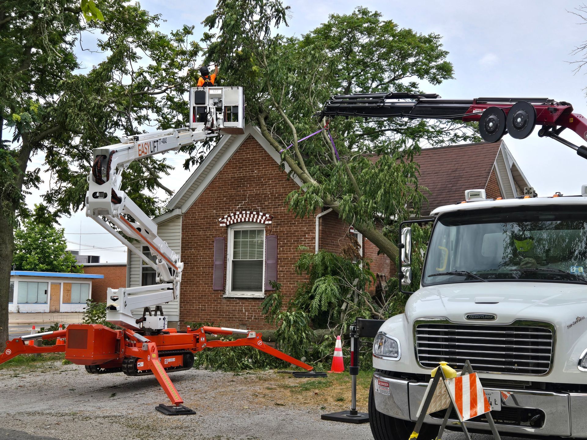 A white truck is parked in front of a brick house.