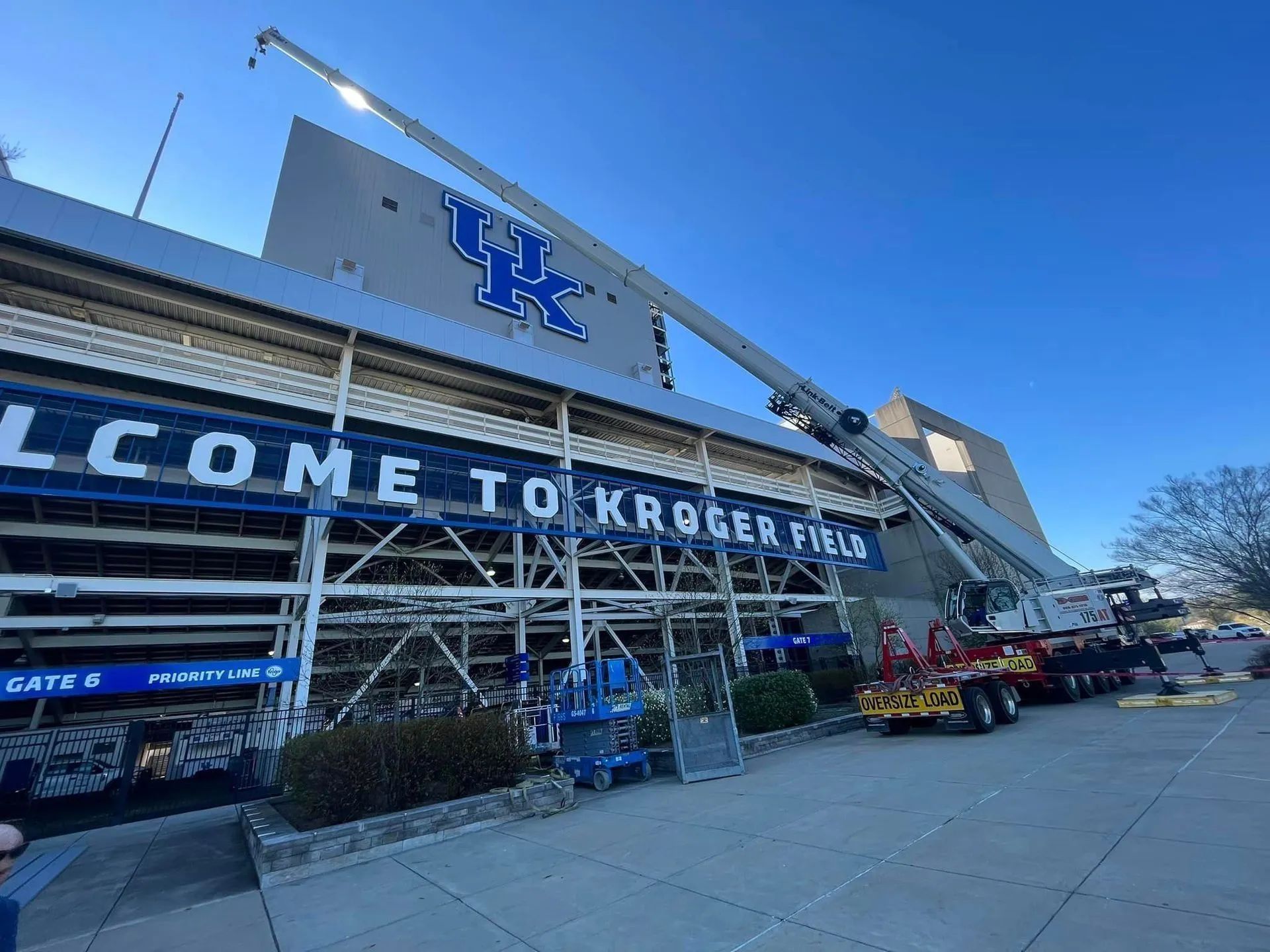 UK football stadium exterior with a crane and fire truck, “Welcome to Kroger Field” sign on the facade
