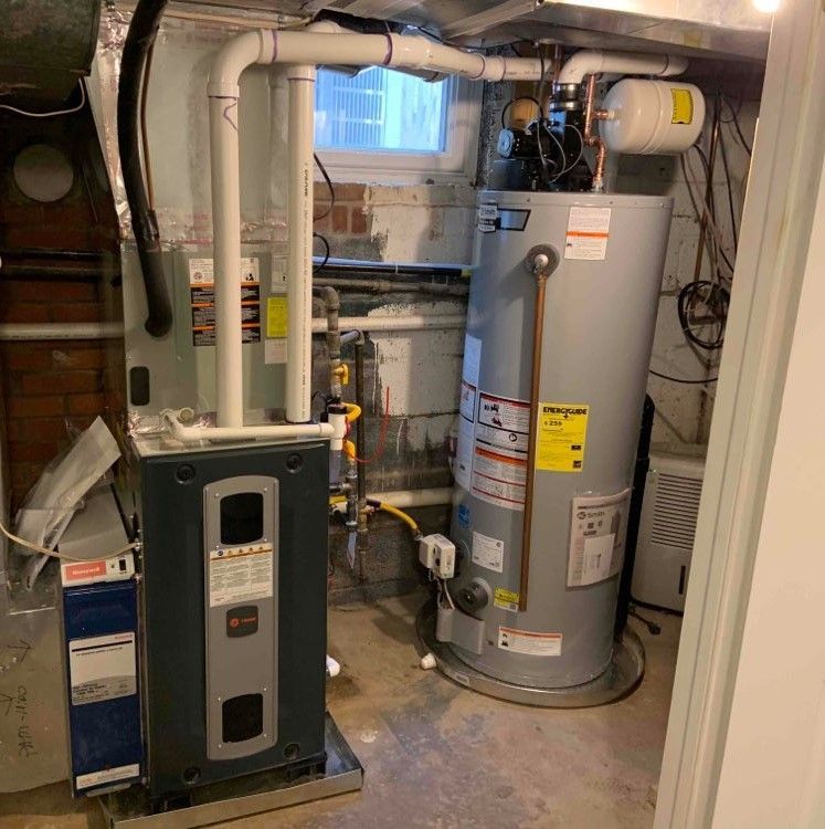 A room with a water heater and a furnace in it