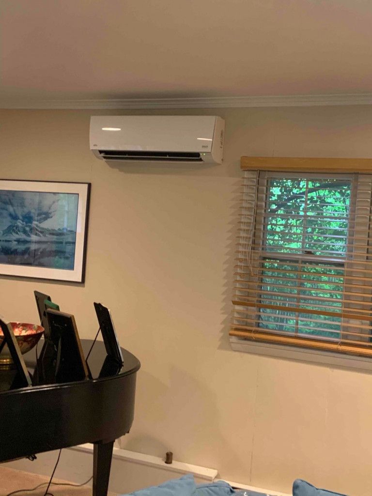 A living room with an inverter AC