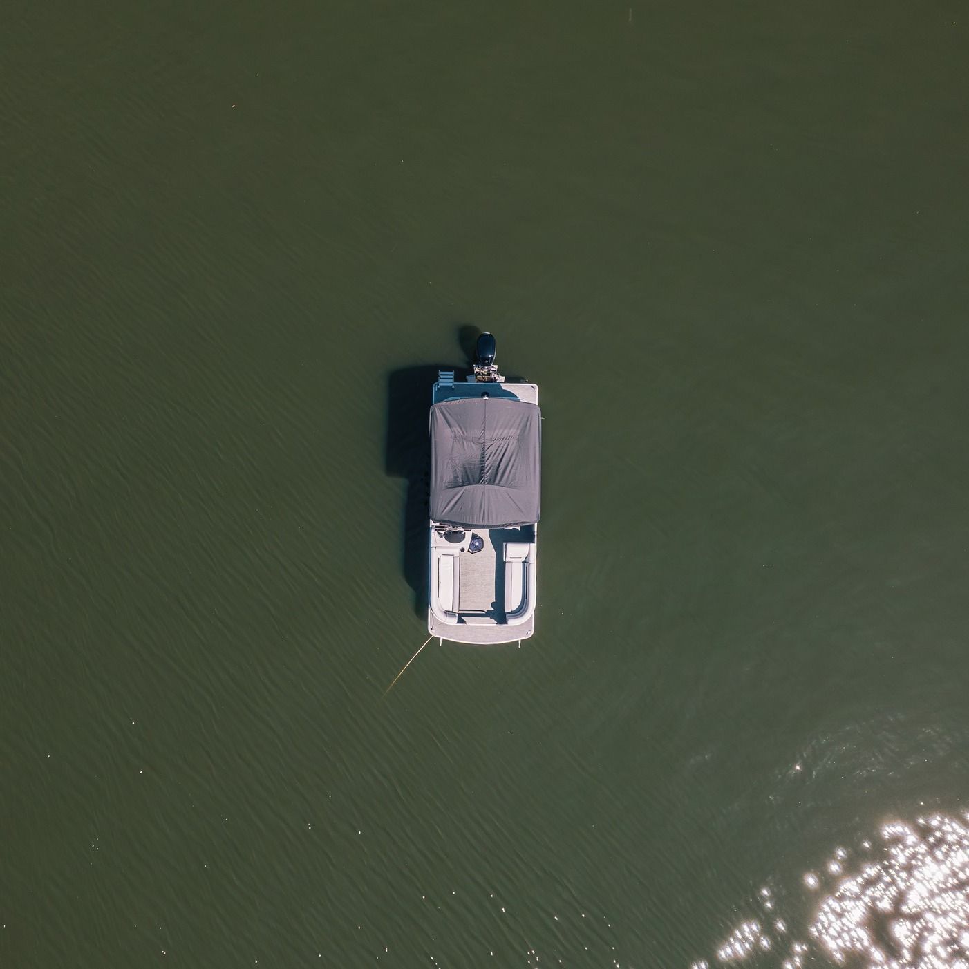 An aerial view of a boat floating on top of a body of water.